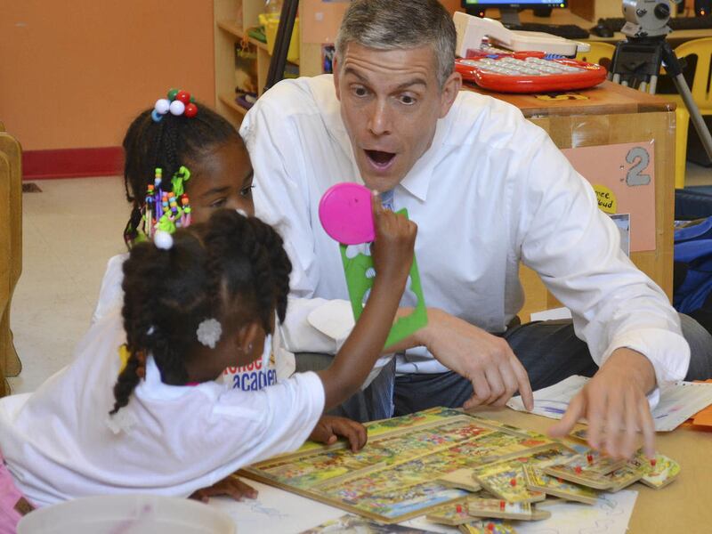 FILE - In thie June 20, 2013, file photo, Education Secretary Arne Duncan visits with young students at the St. Benedict Center for Early Childhood Education in Louisville, Ky.