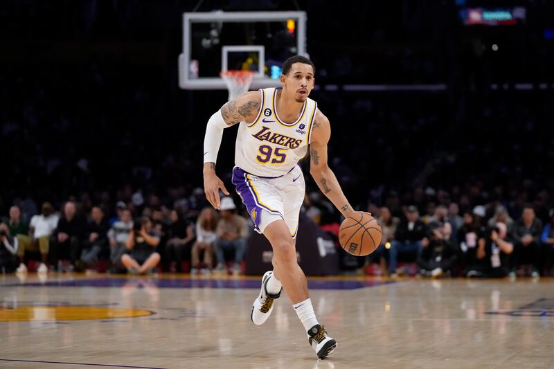 Los Angeles Lakers forward Juan Toscano-Anderson (95) controls the ball during the first half of an NBA basketball game against the Philadelphia 76ers in Los Angeles, Sunday, Jan. 15, 2023. (AP Photo/Ashley Landis)