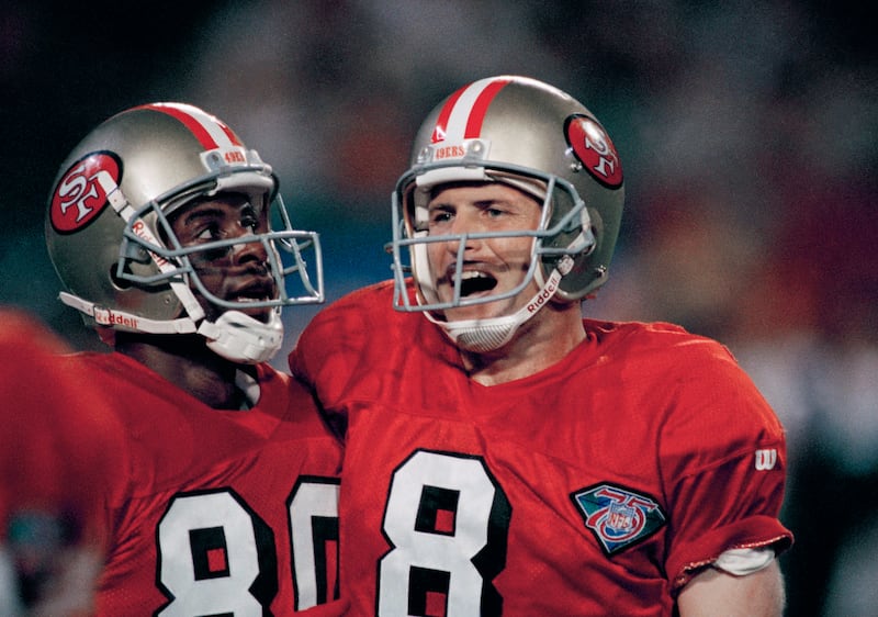 San Francisco 49ers quarterback Steve Young (8) celebrates with wide receiver Jerry Rice in Super Bowl XXIX.