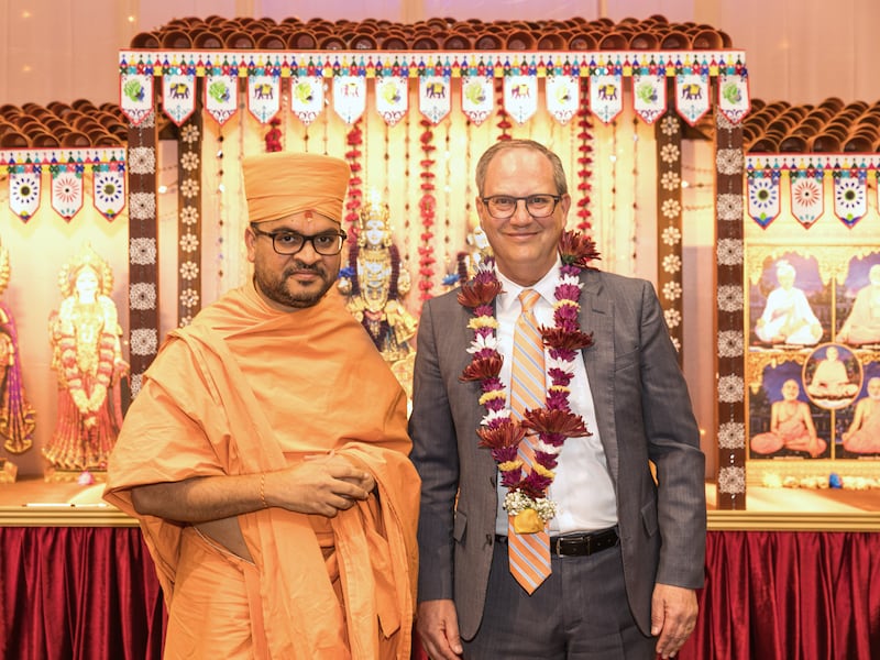 Michael Frandsen of the communication department of The Church of Jesus Christ of Latter-day Saints pauses for a photo with Divyacharandas Swami, a BAPS head swami overseeing the faith’s activities in the western United States, inside the BAPS mandir in Kearns, Utah, on Saturday, Nov. 22, 2025.