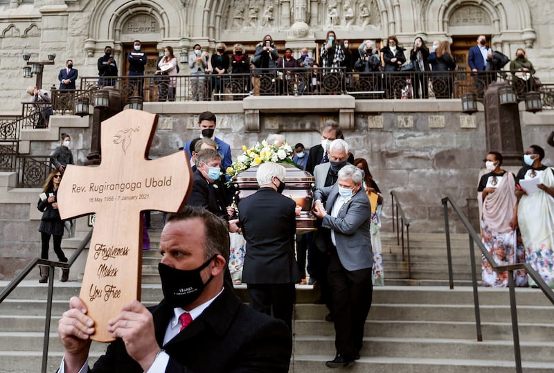 Father Ubald Rugirangoga’s casket is carried out of the Cathedral of the Madeleine following his funeral in Salt Lake City.
