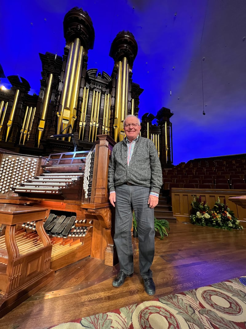 James Higdon stands in front of the historic organ inside the Salt Lake Tabernacle.