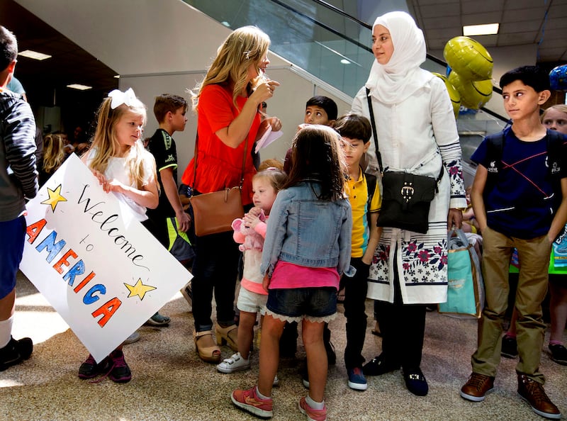 Jamie Cook, a volunteer with Catholic Community Services, welcomes Baraa Huraideen at the Salt Lake City International Airport. After four flights and two days, Huraideen and her family arrived in Utah from Jordan, where they had been refugees. Cook and m