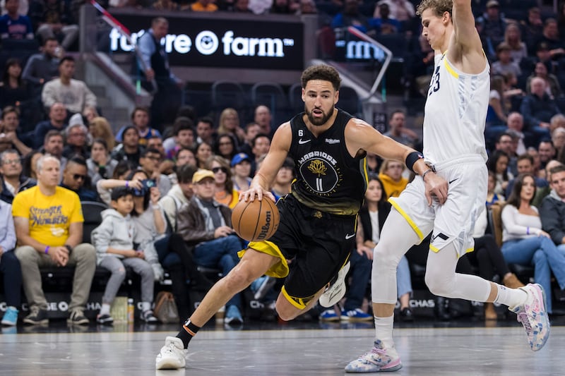 Golden State Warriors guard Klay Thompson (11) drives past Utah Jazz forward Lauri Markkanen, right, during the first half of an NBA basketball game in San Francisco, Friday, Nov. 25, 2022.