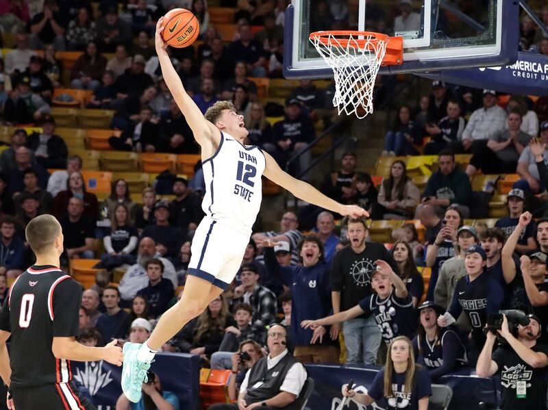 Utah State guard Mason Falslev throws down one of the three dunks he had on three consecutive possessions against during the Aggies' rout of Northwest Nazerene on Dec. 9, 2023, at the Spectrum in Logan.