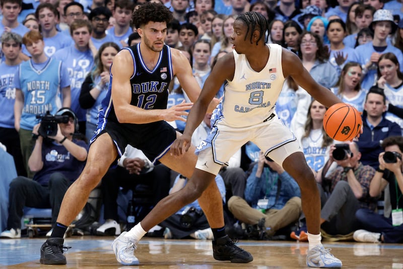 North Carolina forward Caleb Wilson (8) works against Duke forward Cameron Booze during game Saturday, Feb. 7, 2026, in Chapel Hill, N.C. Both players are expected to selected high in June's NBA draft.