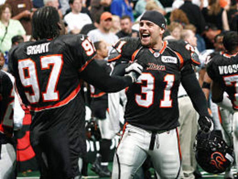 Utah's Chris Robinson (31) is all smiles as he congratulates teammate Ernest Grant after the Blaze beat Kansas City 55-54 Friday night to earn a berth into the AFL playoffs.