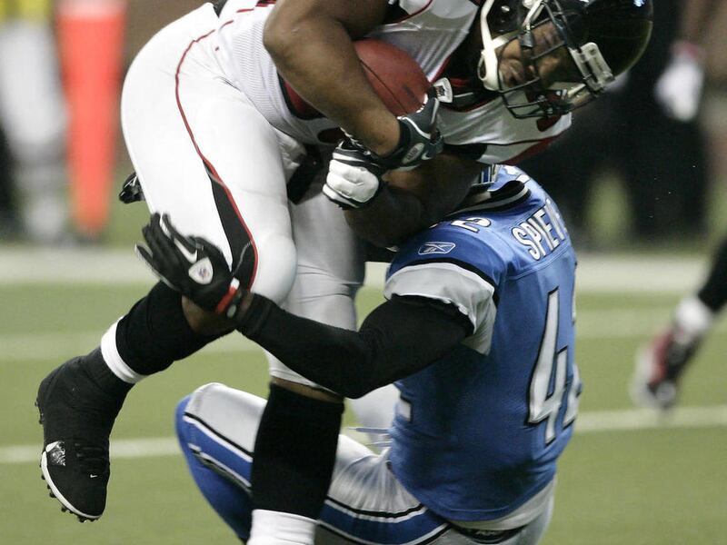 Atlanta Falcons running back Michael Turner (33) is tackled by Detroit Lions strong safety Amari Spievey (42) after a 6-yard gain in the first quarter of an NFL football game Sunday, Oct. 23, 2011 in Detroit.