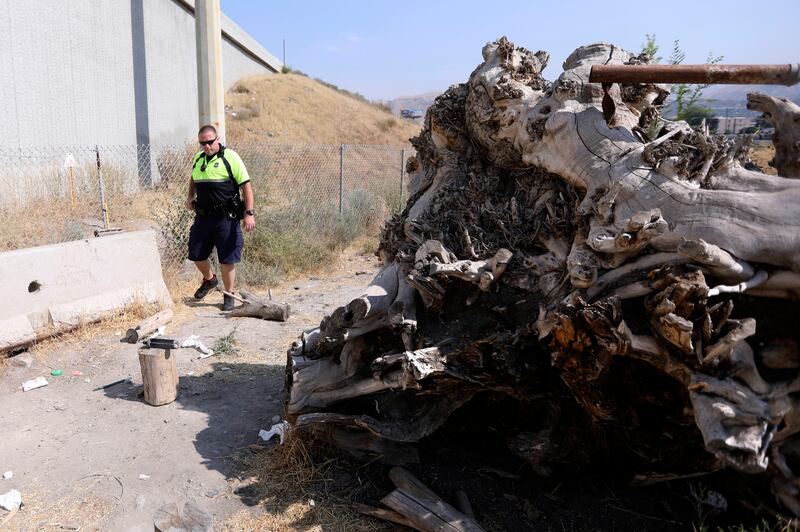 Salt Lake City police officer Austin Gold looks for homeless people camping out in Salt Lake City on Tuesday, Aug. 14, 2018.