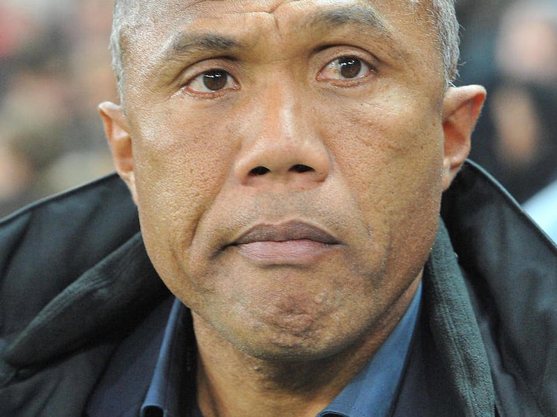 FILE - In this Thursday , Dec. 1, 2011 file photo Paris St-Germain head coach Antoine Kombouare looks on prior to the Group F Europa League soccer match between Red Bull Salzburg and Paris St. Germain in Salzburg, Austria. Paris Saint-Germain has confir