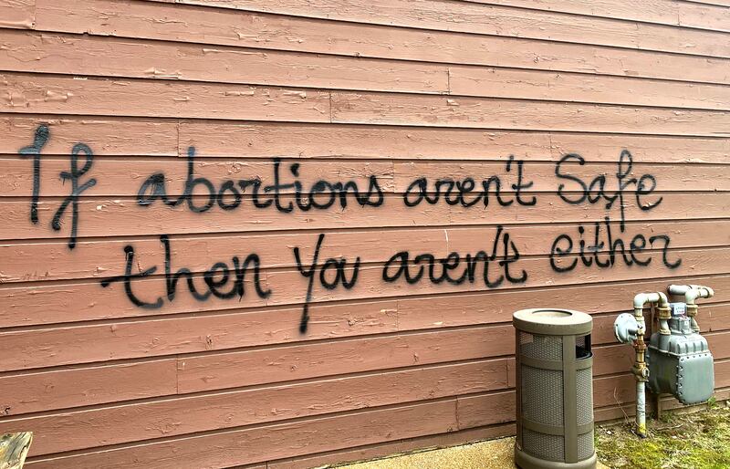 Threatening graffiti is seen on the exterior of Wisconsin Family Action offices.
