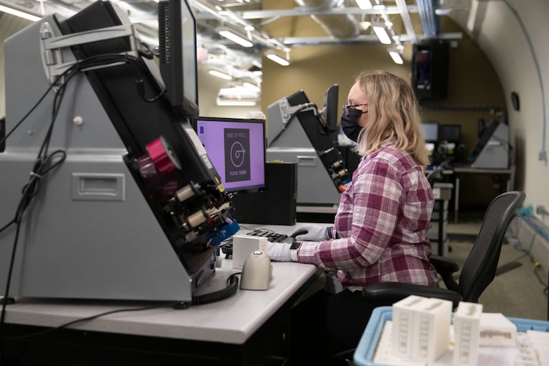 A woman uses technology to digitize family history records for The Church of Jesus Christ of Latter-day Saints.