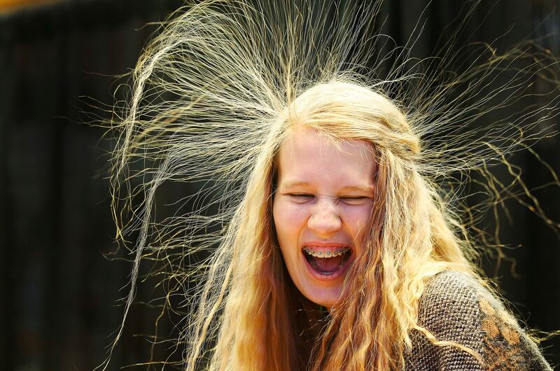 FILE - Nicole Peterson's hair raises from static after touching a Van de Graaff machine during SheTech Explorer Day at Utah Valley University in Orem on Friday, March 3, 2017. Students of all ages will have the chance to explore the fun side of science, t