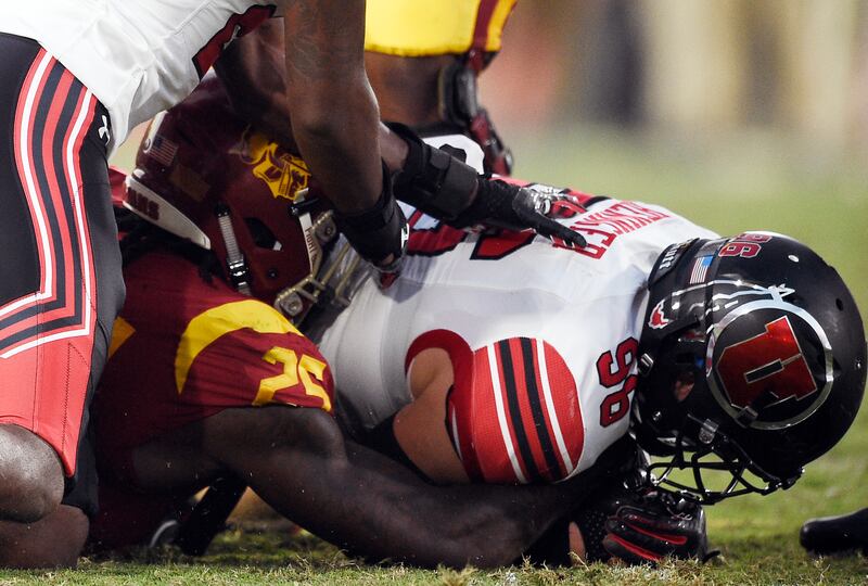 Utah defensive end Nick Heninger, right, recovers a fumble off a backward pass to Southern California running back Ronald Jones II during the first half of an NCAA college football game in Los Angeles, Saturday, Oct. 14, 2017.