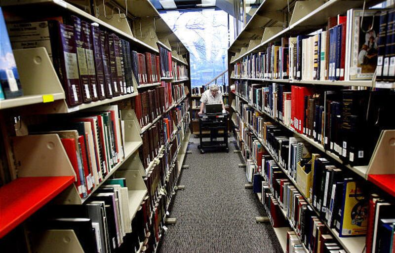 Pauline Musig walks down an aisle in the LDS Church History Library on Friday. Musig is overseeing the scanning of books and documents in preparation for the move to the new Church History Library, which will be dedicated June 20.