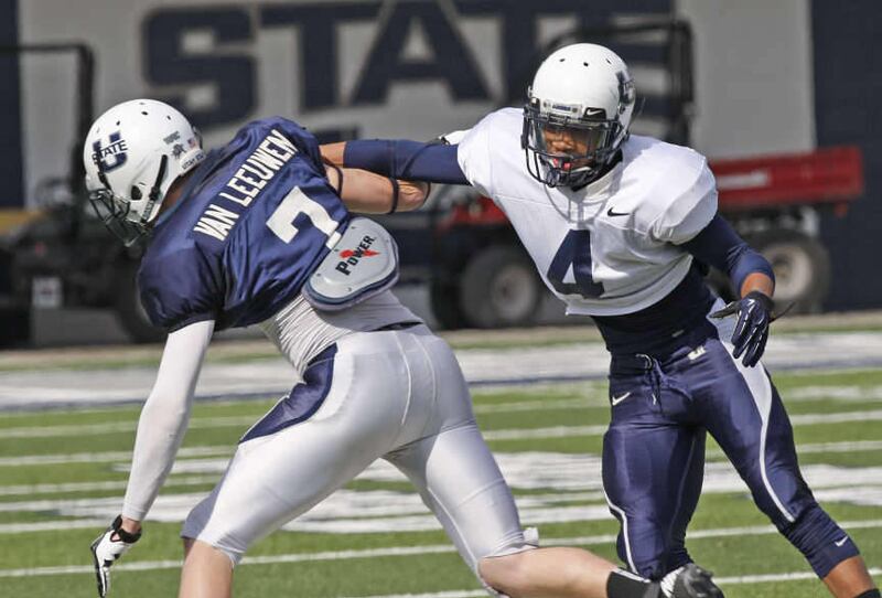 Defensive back Devonta Glover-Wright defends Travis Van Leeuwen during Utah State Aggies football practice Thursday, March 28, 2013, in Logan