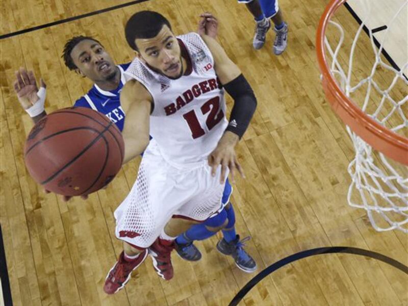 Wisconsin guard Traevon Jackson (12) drives to the basket past Kentucky guard James Young during the second half of an NCAA Final Four tournament college basketball semifinal game Saturday, April 5, 2014, in Arlington, Texas. Kentucky won 74-73. (AP Photo