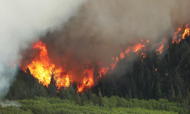 The Dollar Ridge Fire burns at Strawberry Reservoir on Friday, July 6, 2018.