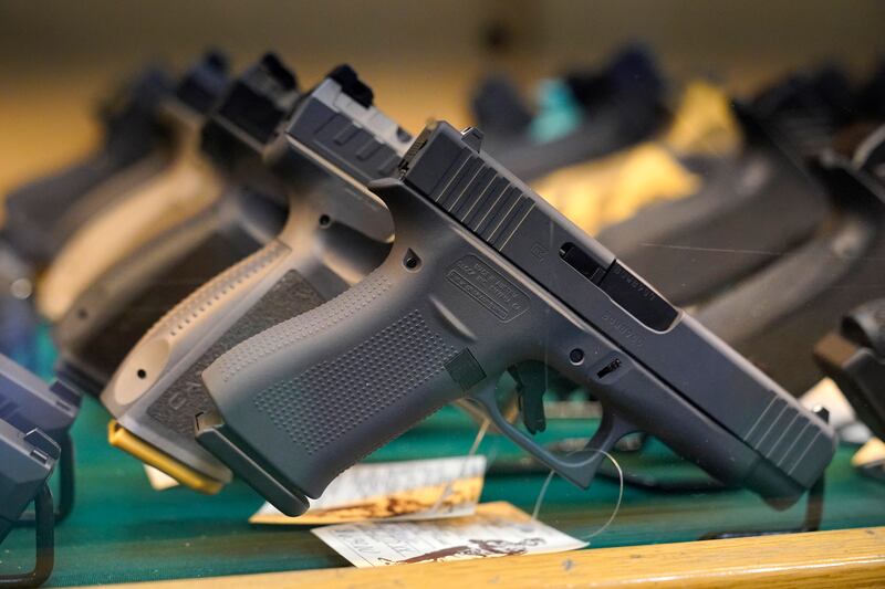 Handguns are displayed at a pawn shop Monday, July 18, 2022, in Auburn, Maine.
