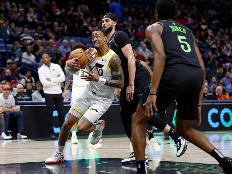 Utah Jazz forward John Collins (20) is fouled by New Orleans Pelicans forward Larry Nance Jr. during the first half of an NBA basketball game in New Orleans, Tuesday, Jan. 23, 2024. (AP Photo/Tyler Kaufman)