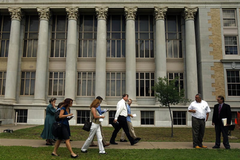 Reporters walk beside FLDS spokesman Willie Jessop outside the Tom Green County Courthouse in August 2008.
