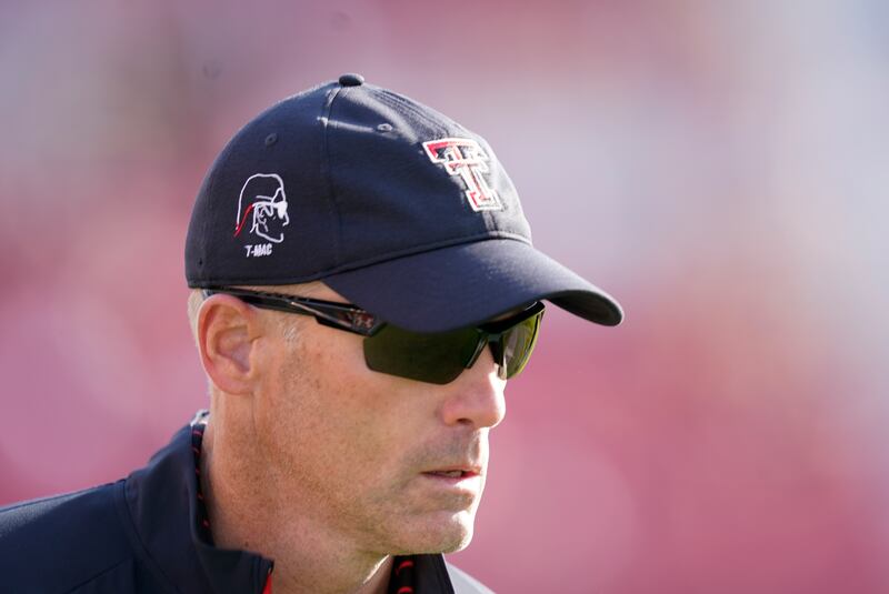 Texas Tech head coach Matt Wells runs off the field at the end of the first half of an NCAA college football game against Iowa State in Ames, iowa