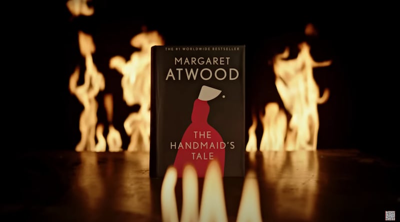 A screenshot from a Penguin Random House video showing a fire-resistant copy of “The Handmaid’s Tale,” by Margaret Atwood.