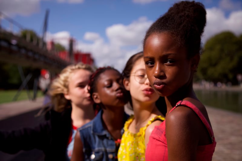 This image released by Netflix shows the cast of the coming-of-age film “Cuties.” The backlash to the French independent film “Mignonnes,” or “Cuties,” started before it had even been released because of a poster that went viral for its provocative depiction of its young female actors.