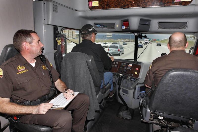 Troopers Mike Bennett, left, and Brad Clayton travel with driver Chad Lund as the Utah Highway Patrol spots violators for the Ticketing Aggressive Cars & Trucks enforcement period kickoff Monday, April 25, 2011, in Murray.
