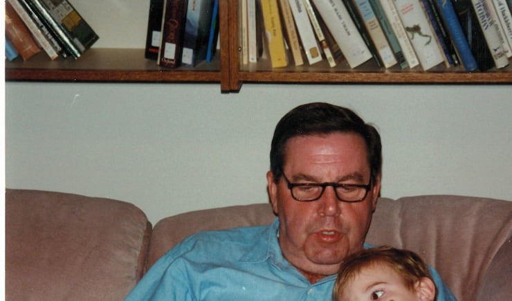Elder Jeffrey R. Holland reads to a grandson.