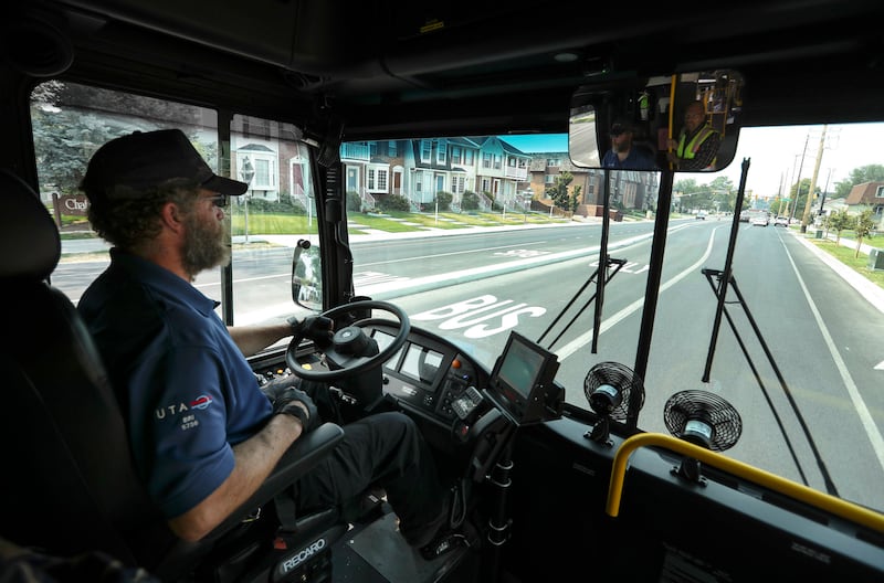Utah Transit Authority bus operator Briant Thorne drives through a Provo neighborhood in a hybrid electric articulated bus during a test run of the Utah Valley Express on Friday, Aug. 10, 2018. The bus rapid transit line service starts Monday.