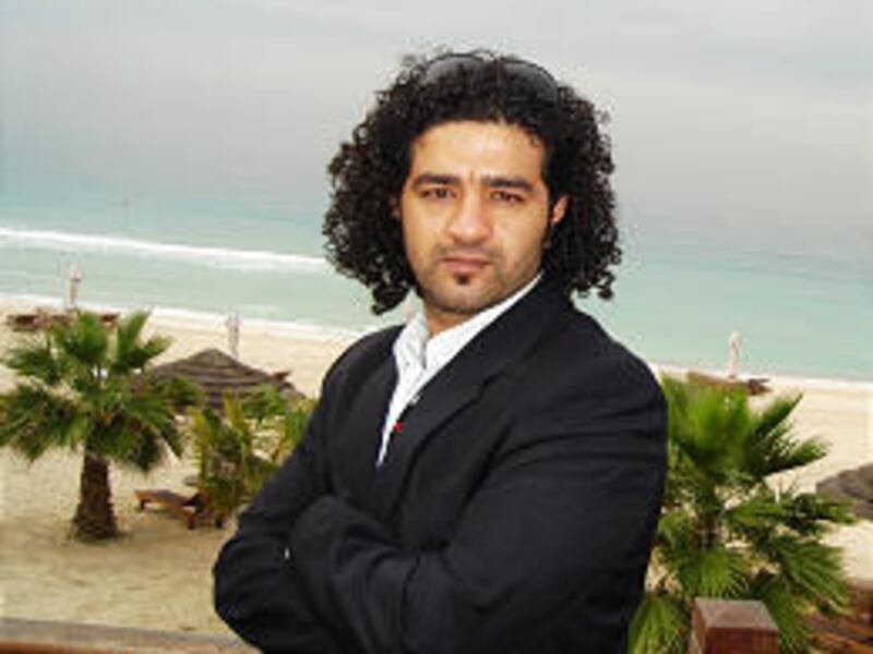 Mohamed Al-Daradji is pictured after the fall of Saddam Hussein. He sometimes had to use car headlights to light his movie sets.