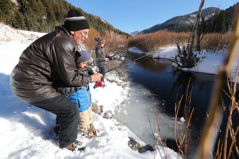 Viktor Stulishaiko helps his grandson Tristan Epperson as they fish with another grandson, Sebastien, in Big Cottonwood Canyon on Sunday, Nov. 25, 2018.