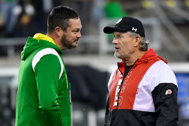 Oregon head coach Dan Lanning and Utah head coach Kyle Whittingham talk before a game, Nov. 19, 2022, in Eugene, Ore.