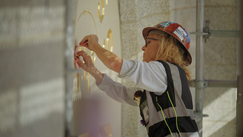 Anne Domenech, an artist with Evergreen, works to restore the "Holiness to the Lord" panel on the Salt Lake Temple of The Church of Jesus Christ of Latter-day Saints on Monday, Aug. 18, 2025.