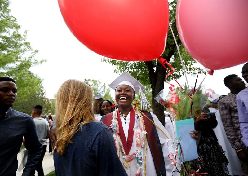 Desange Kuenihira is greeted by friends and family after the Itineris Early College High School graduation ceremony at Thanksgiving Point in Lehi on Wednesday, May 15, 2019. When Kuenihira was a young girl growing up in a refugee camp without parents, she