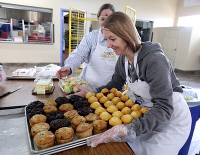 Latter-day Saint Cheryl Leithead loads up a trey of muffins while volunteering at St. Vincent de Paul Dining Hall in Salt Lake City on Thursday, March 7, 2019.