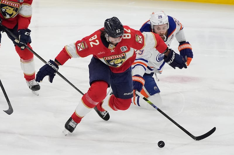 Edmonton Oilers center Leon Draisaitl (29) and Florida Panthers center Kevin Stenlund (82) go after the puck during Game 7 of the Stanley Cup Final, Monday, June 24, 2024, in Sunrise, Fla.