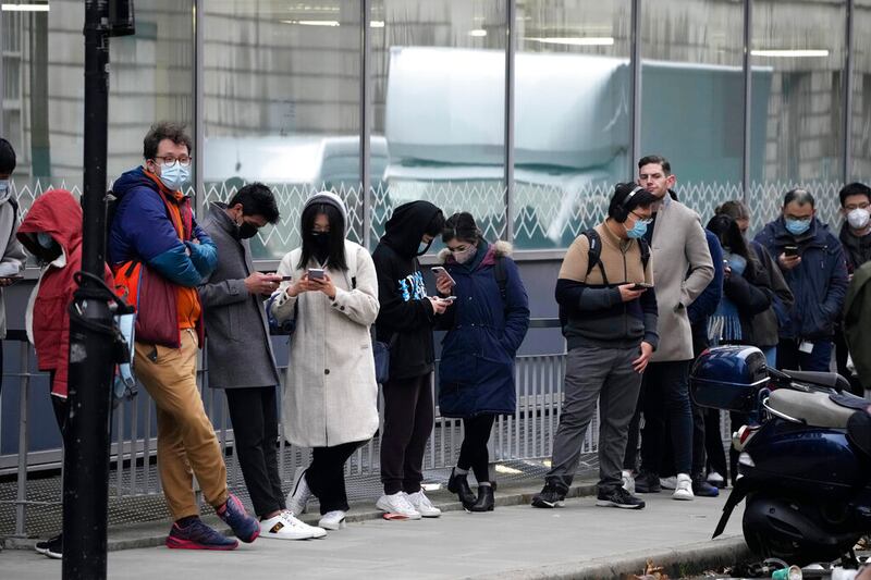 People queue up to get COVID-19 booster injections.