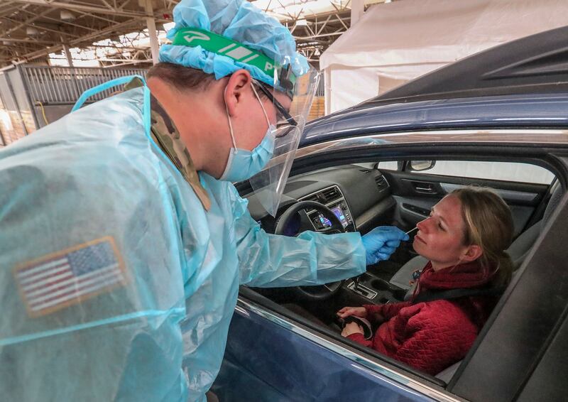 Utah National Guard soldier Ebbin Wyatt administers a COVID-19 test to Heidi Prior at the Utah State Fairpark in Salt Lake City on Monday, March 8, 2021. People who were naturally infected with COVID-19 might only have immunity that lasts six months