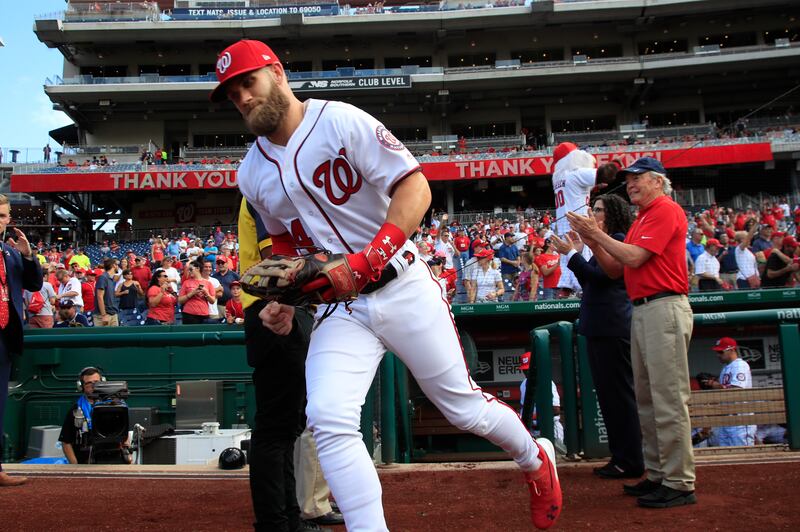 Washington Nationals right fielder Bryce Harper (34), runs to the field from the dug out at the start of the Nationals last home game of the season during a baseball game against the Miami Marlins in Washington, Wednesday, Sept. 26, 2018. (AP Photo/Manuel