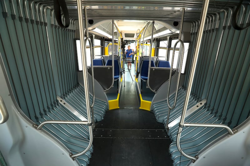 Mary DeLaMare-Schaefer, regional general mangers at the Utah Transit Authority, stands in the isle of a hybrid electric articulated bus at the Orem Central FrontRunner station during a test run of the Utah Valley Express on Friday, Aug. 10, 2018. The bus
