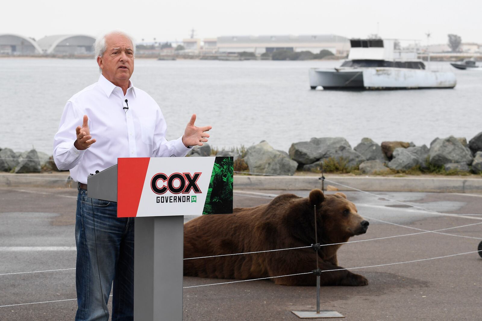 California gubernatorial candidate John Cox speaks in front of his Kodiak bear at a campaign event in San Diego.