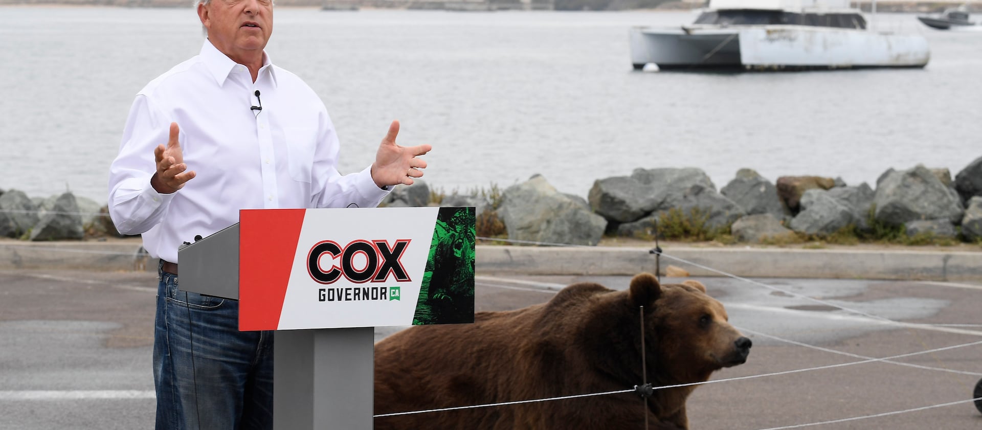 California gubernatorial candidate John Cox speaks in front of his Kodiak bear at a campaign event in San Diego.