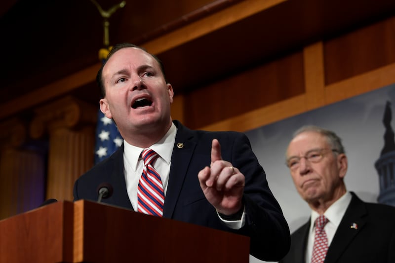Sen. Mike Lee, R-Utah, left, speaks during a news conference on Capitol Hill in Washington.