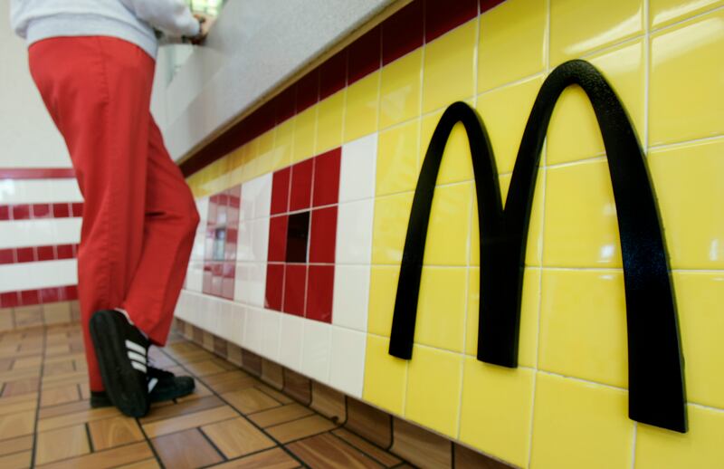 A patron picks up her lunch order at a McDonald’s restaurant.