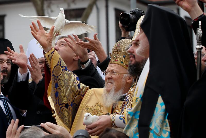 Ecumenical Patriarch Bartholomew I, center, Metropolitan Epiphanius, the head of the independent Ukrainian Orthodox Church, second right, and then-Ukrainian President Petro Poroshenko, third left, release birds during a symbolic ceremony sanctifying the Ukrainian church’s independence from the Russian Orthodox Church, in Istanbul, on Jan. 6, 2019.