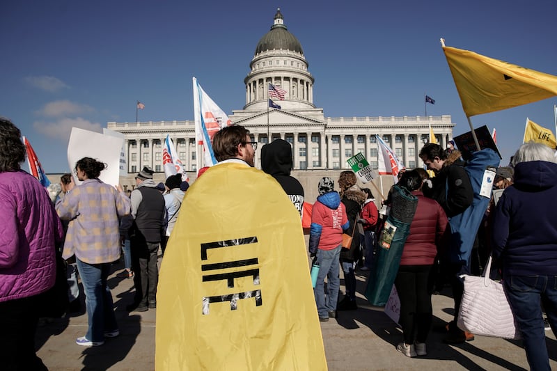 A rallygoer with a “life” flag is pictured before a March for Life rally in Salt Lake City.