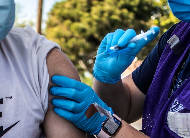 Freddy Centeno receives a COVID-19 vaccine.