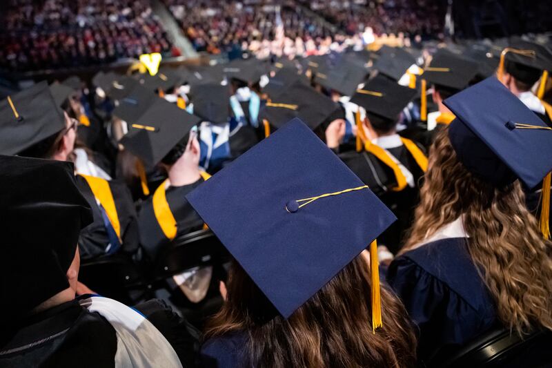 A group of university graduates are pictured at commencement on April 27, 2023.